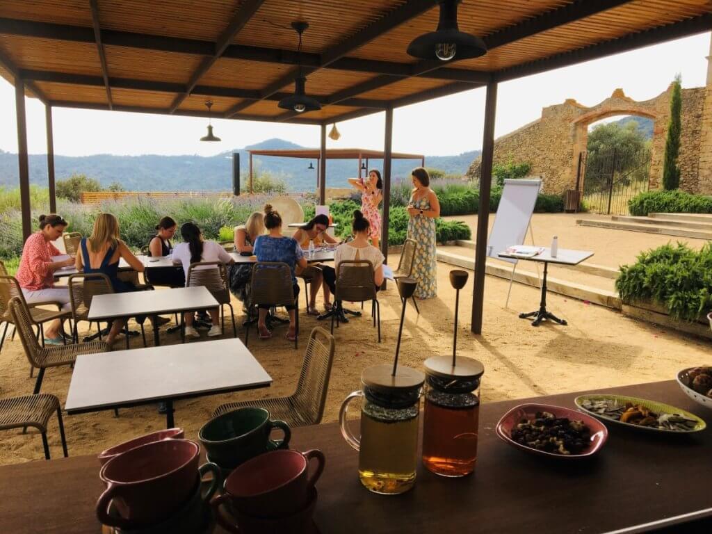 Guests enjoying an outdoor meeting and refreshments at a private villa, perfect for private villas for families.