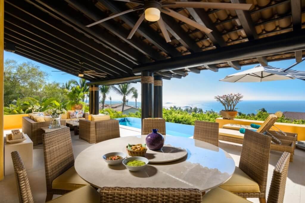 Villa Maria’s open air terrace with ocean views and infinity pool reflects why it ranks among the best villas for luxury honeymoons.