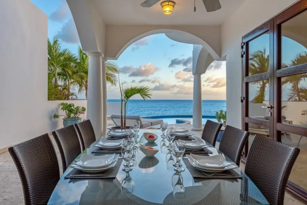 Outdoor dining terrace with ocean view at Villa Mumbai, St Martin, highlighting amenities to check in a luxury villa booking checklist
