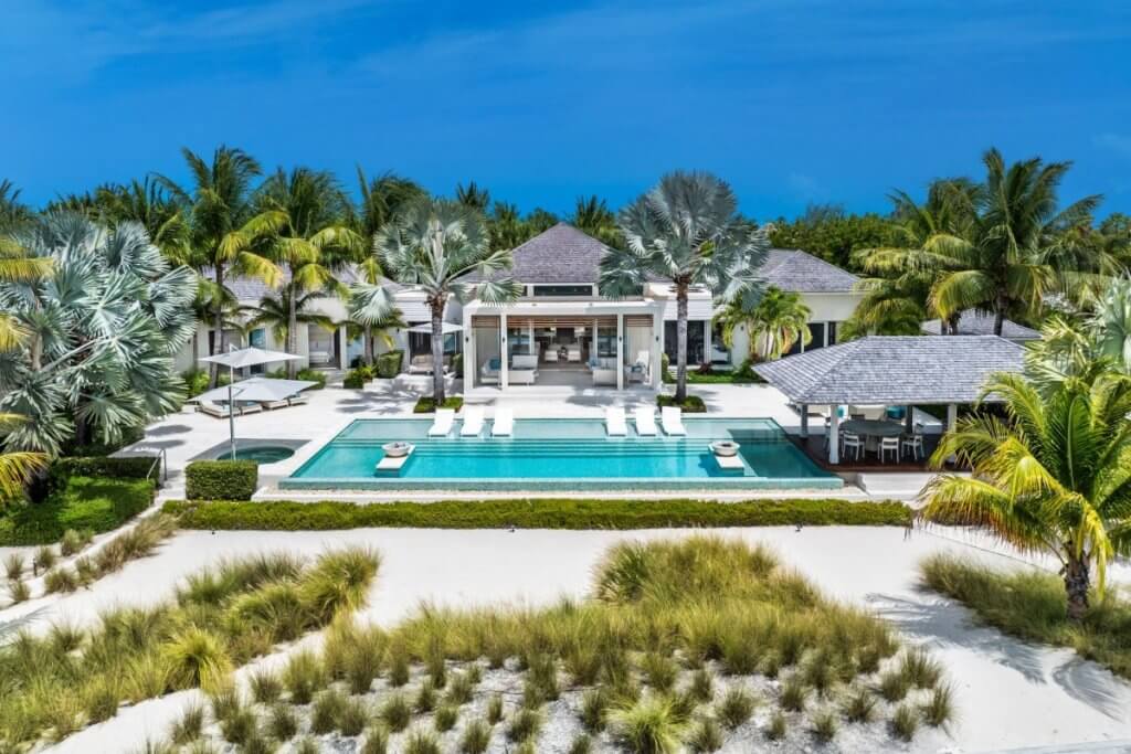 Villa Sentosa’s beachfront estate with infinity pool and loungers.