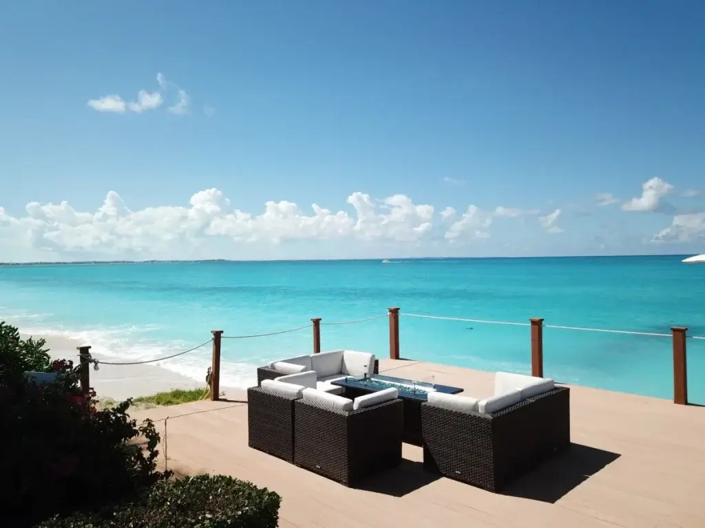 Oceanfront terrace at Sunsara, Turks & Caicos, with lounge seating and panoramic sea views, a key detail in a luxury villa booking checklist.