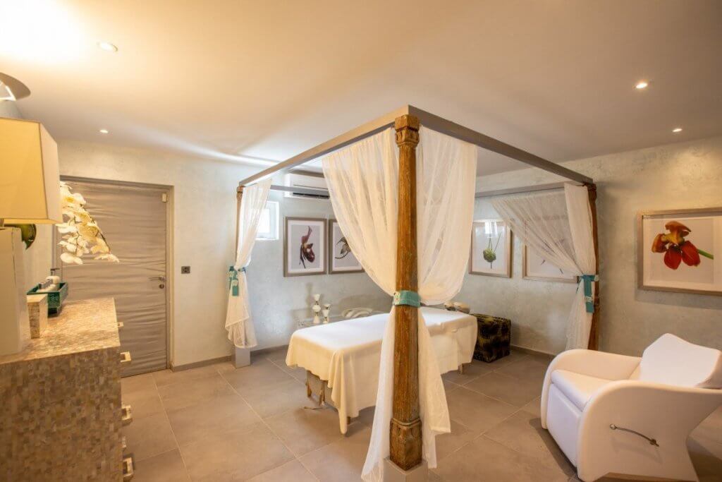 Le Reve St Martin villa spa room with canopy massage table, mosaic counter, and tranquil botanical décor.