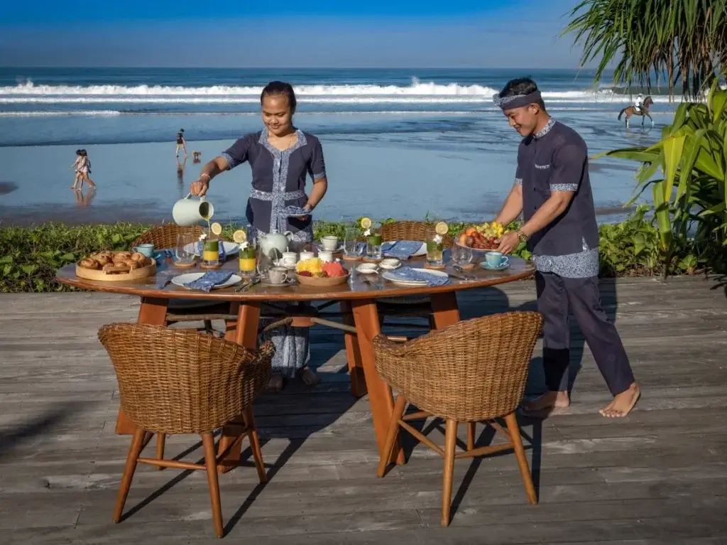 Private beachfront breakfast at Noku Beach House, Bali, with discreet staff service and ocean views defining Bali’s hidden luxury