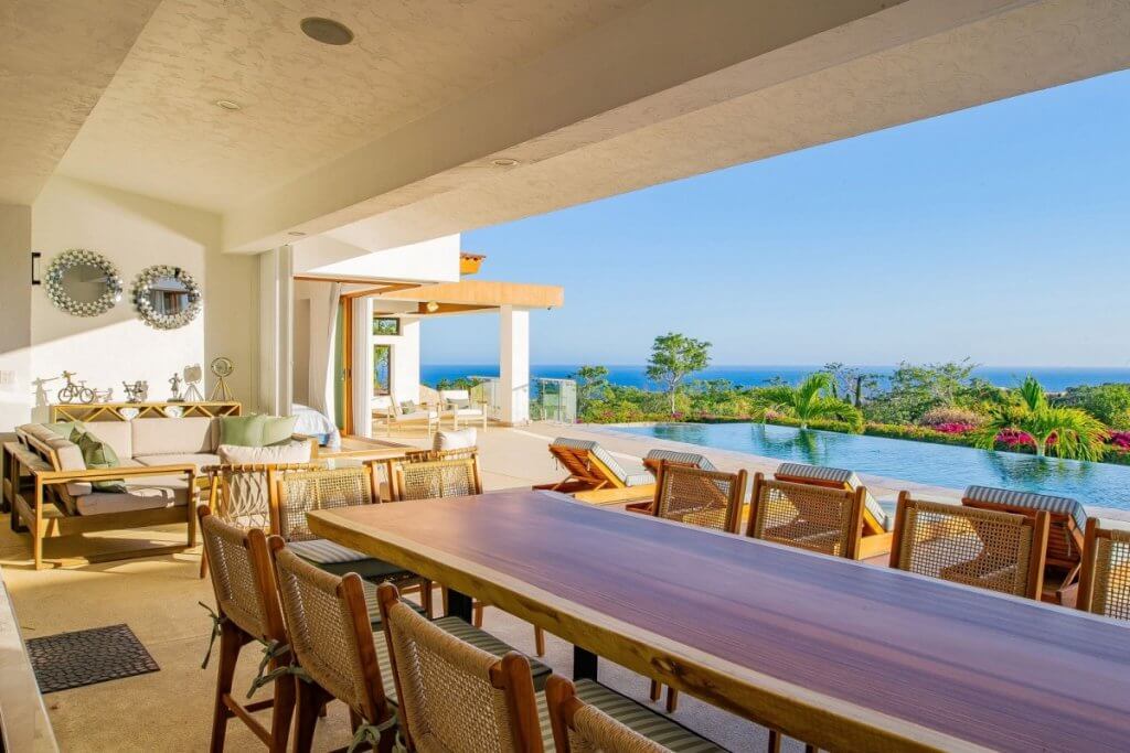 Open-air dining terrace and infinity pool at Casa Primavera, Los Cabos, reflecting Mexico or the Caribbean luxury travel through space and flow.