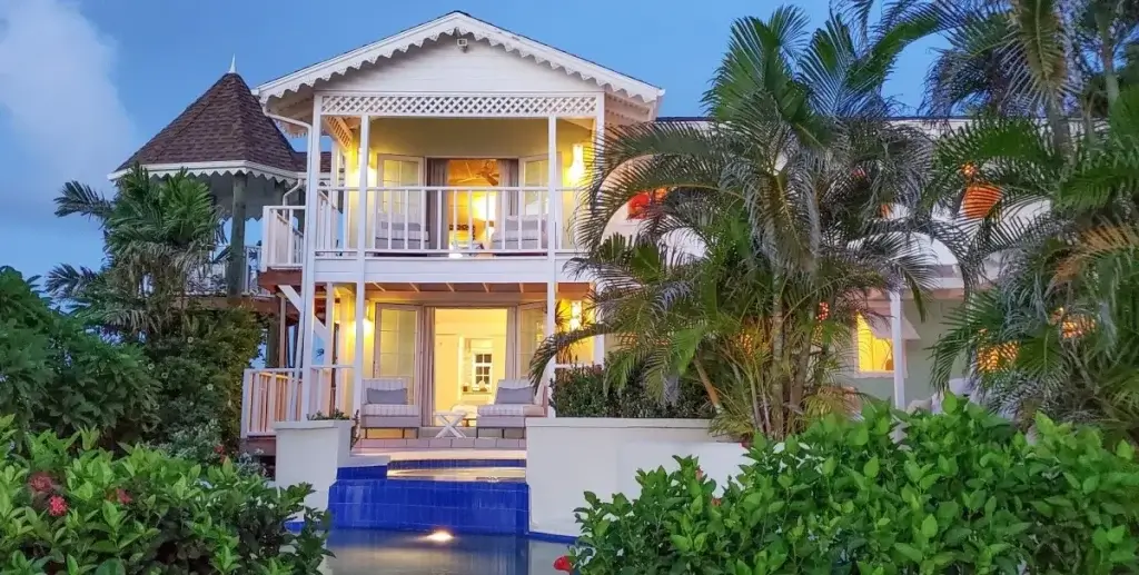 Evening view of Saline Reef, St Lucia, a private residence with terraces, pool, and tropical gardens, reflecting St. Lucia luxury villas.