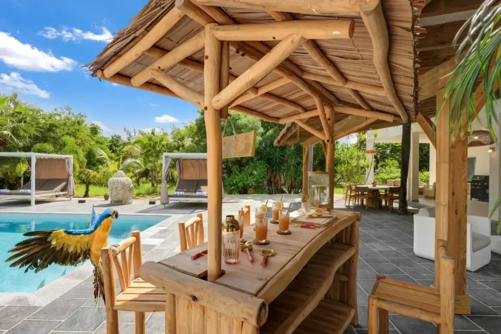 Open-air poolside bar at Nirvana, St Martin, expressing Mexico or the Caribbean luxury travel through relaxed outdoor living and privacy.