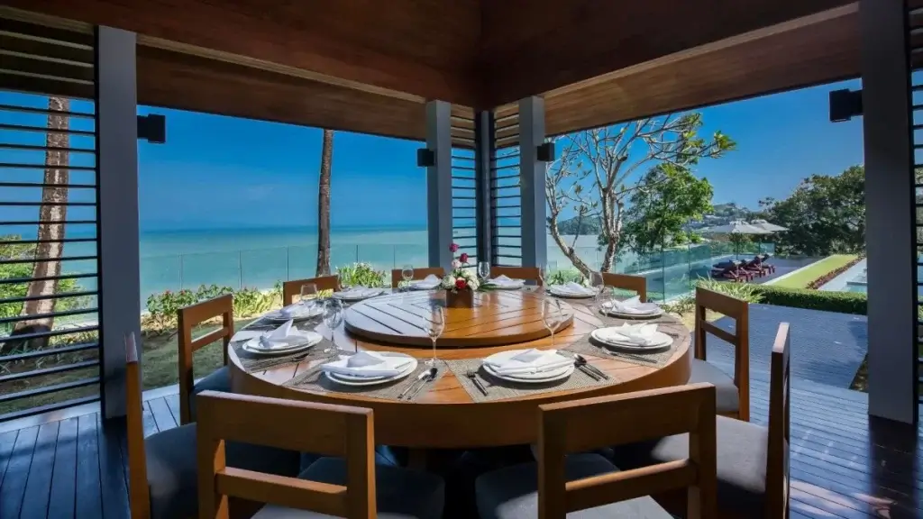 Open-air dining pavilion at Villa Sawarin overlooking the sea, showcasing space and privacy in Thailand luxury travel