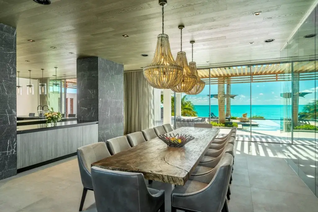 Oceanview dining area at Legasea Turks and Caicos family villas with open-plan kitchen and terrace access