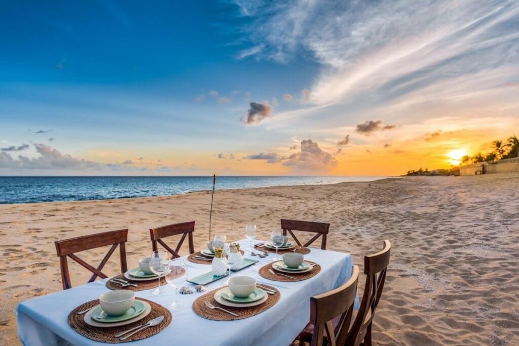 Casa de la Playa beachfront dinner setup at sunset