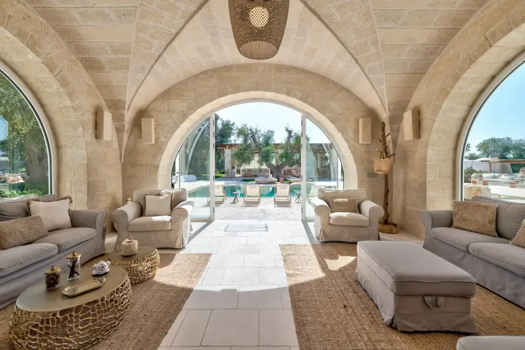 Italian summer escapes Villa Brezzablu Puglia stone interior with arched ceilings and poolside view