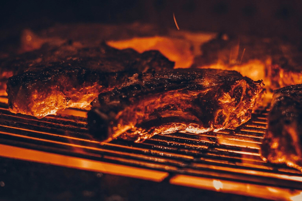 Open-fire grilled steaks showcasing Where to Eat in Marbella for elevated luxury dining experiences