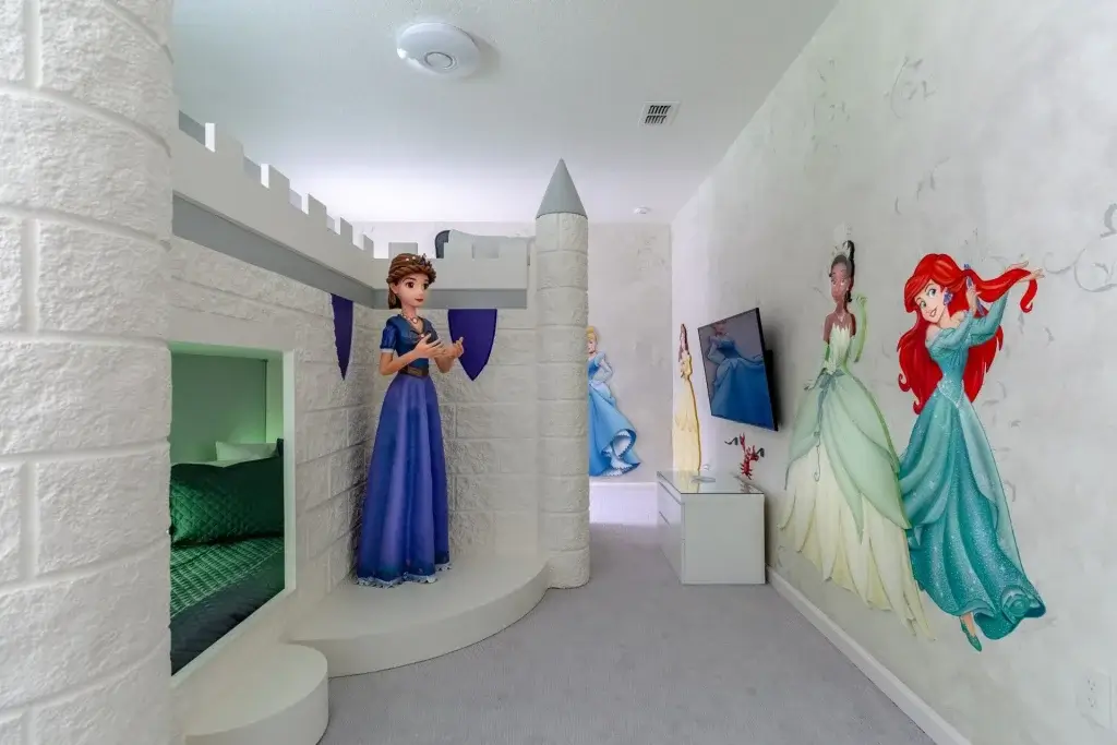 Princess-themed bedroom at Princess Pad Orlando with castle bunk beds, storybook murals, and immersive kids décor