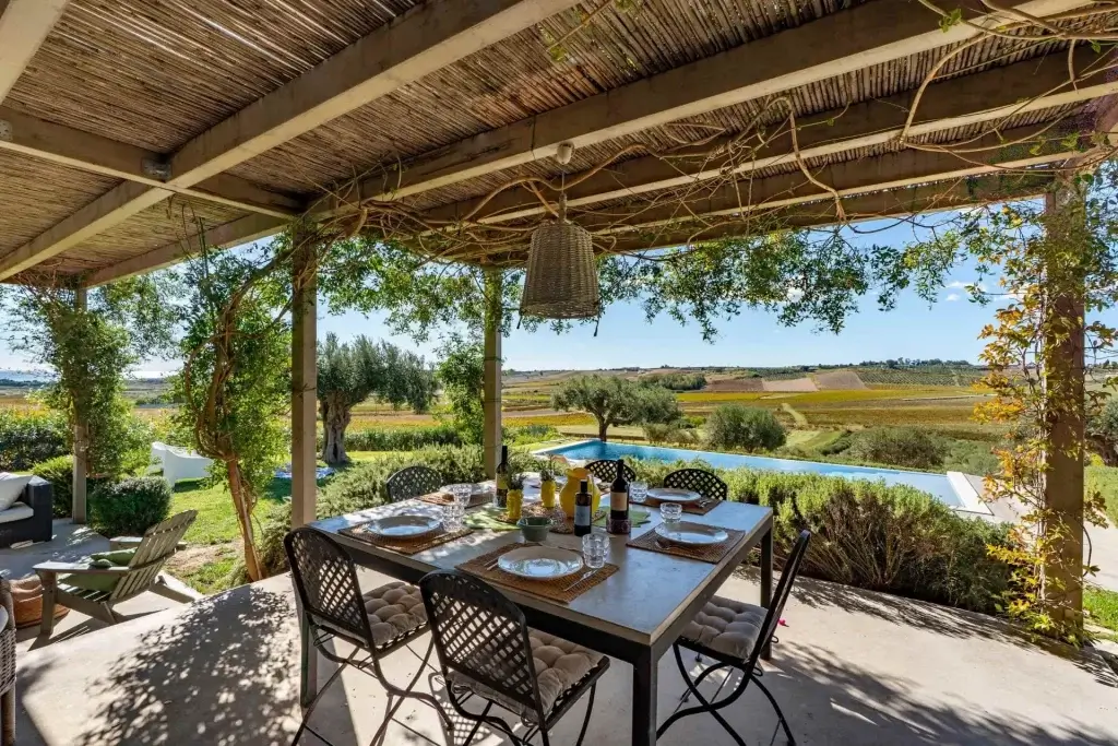 Alfresco dining terrace at Arete, Sicily overlooking vineyards and infinity pool scenery