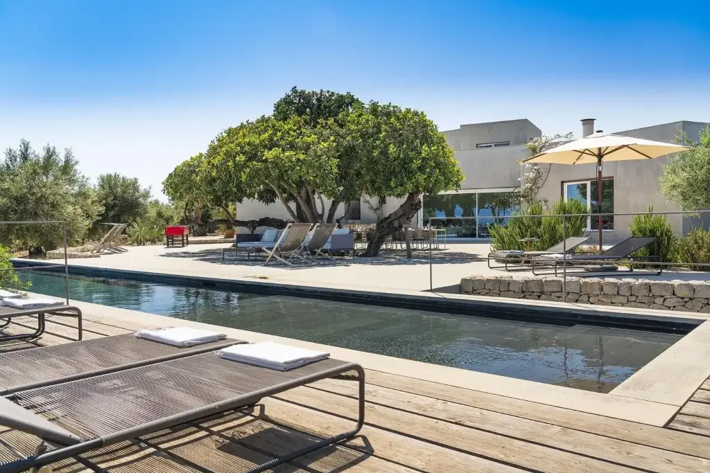 Luxury Sicily Villas pool terrace at Orizzonte, Sicily surrounded by olive trees and modern Mediterranean design