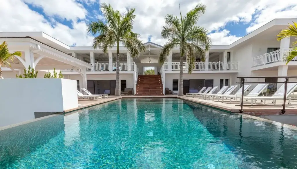Villa Always private infinity pool surrounded by palm trees and elegant Caribbean luxury villa architecture