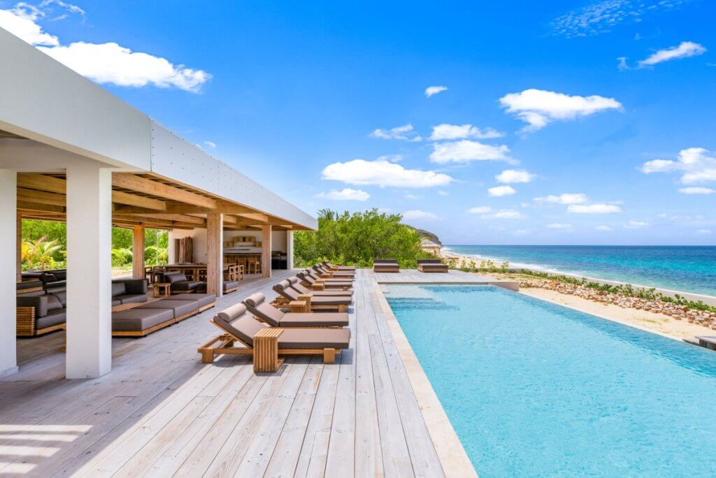 Beachfront Caribbean luxury villa in St Martin with an expansive private pool, oceanfront terrace, and open-air lounge