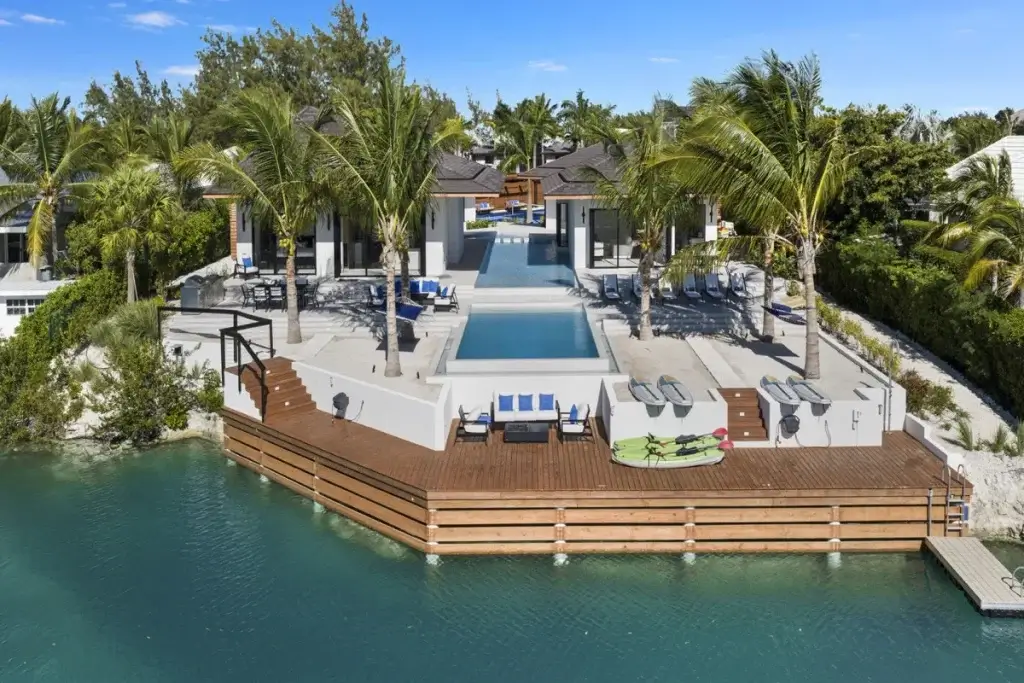 Aqua Solis waterfront villa in Turks and Caicos with private pool, dock, palm-lined terraces, and canal views