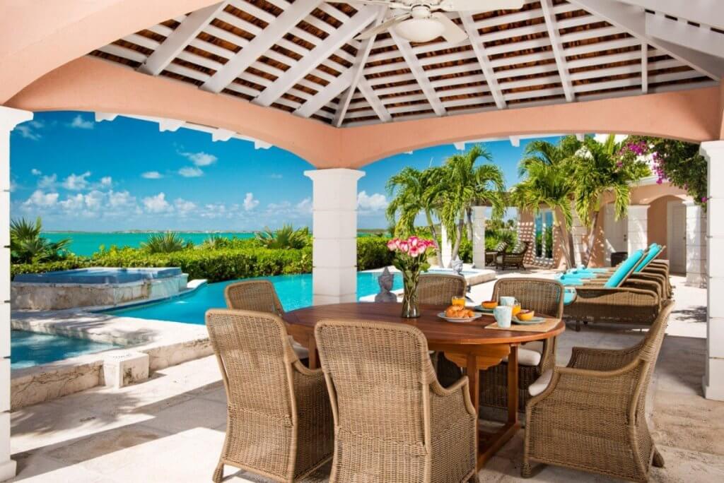 Villa Osprey infinity pool overlooking turquoise waters in a serene Turks and Caicos waterfront villa setting