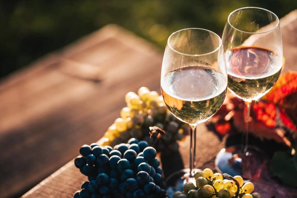 Unique Wine Tour in the Amalfi Area with wine glasses, grapes, and a refined tasting table.