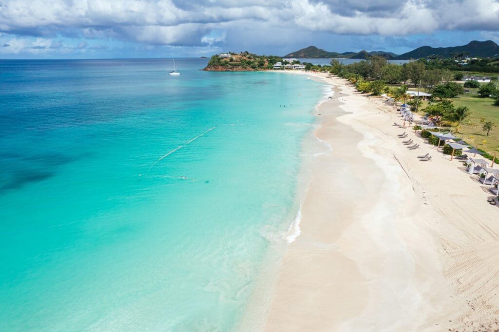 Ffryes Beach near Tamarind Hills Antigua with turquoise water, soft sand, loungers, and calm shoreline