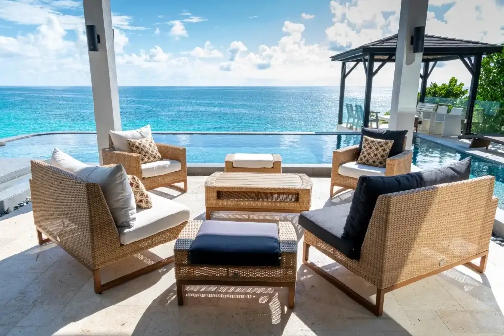 Barracuda B8 ocean-view pool terrace with shaded lounge, wicker seating, and turquoise Caribbean water