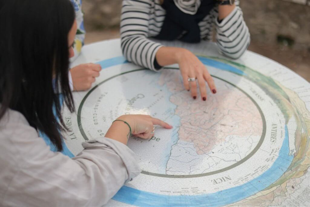 Travelers reviewing a Côte d’Azur map before exploring Nice, Cannes and Antibes