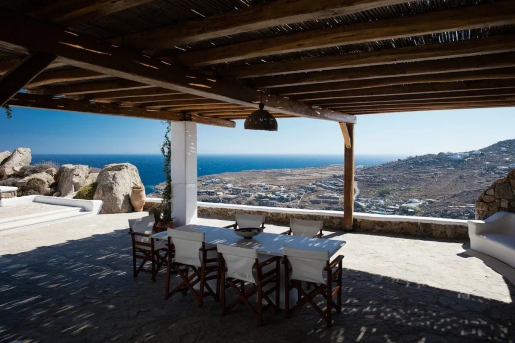 Villa Paradiso Mykonos shaded dining terrace with sweeping Aegean views