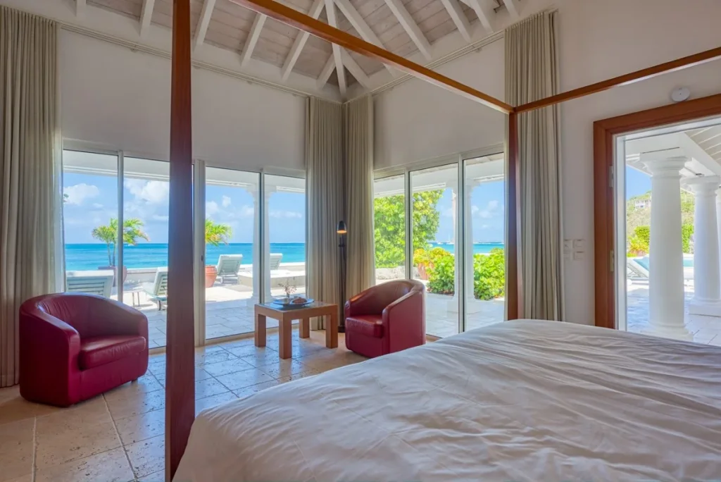 Oceanfront bedroom with terrace access at Petite Plage 5, St. Martin