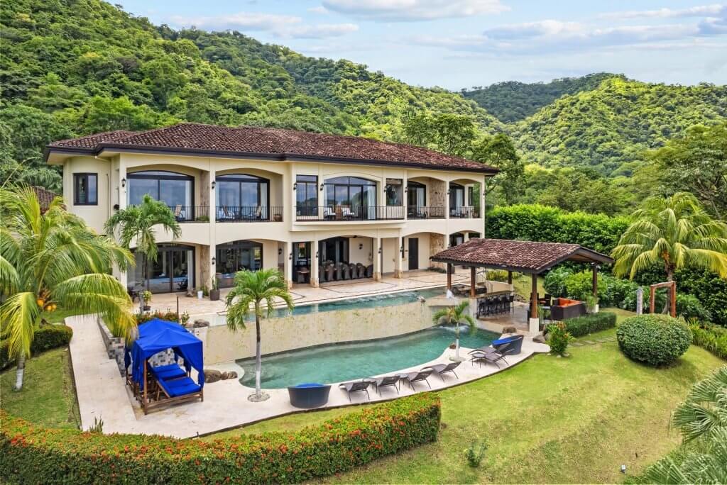 Villa Buena Onda with a two-tiered infinity pool, swim-up bar, and lush Guanacaste hills