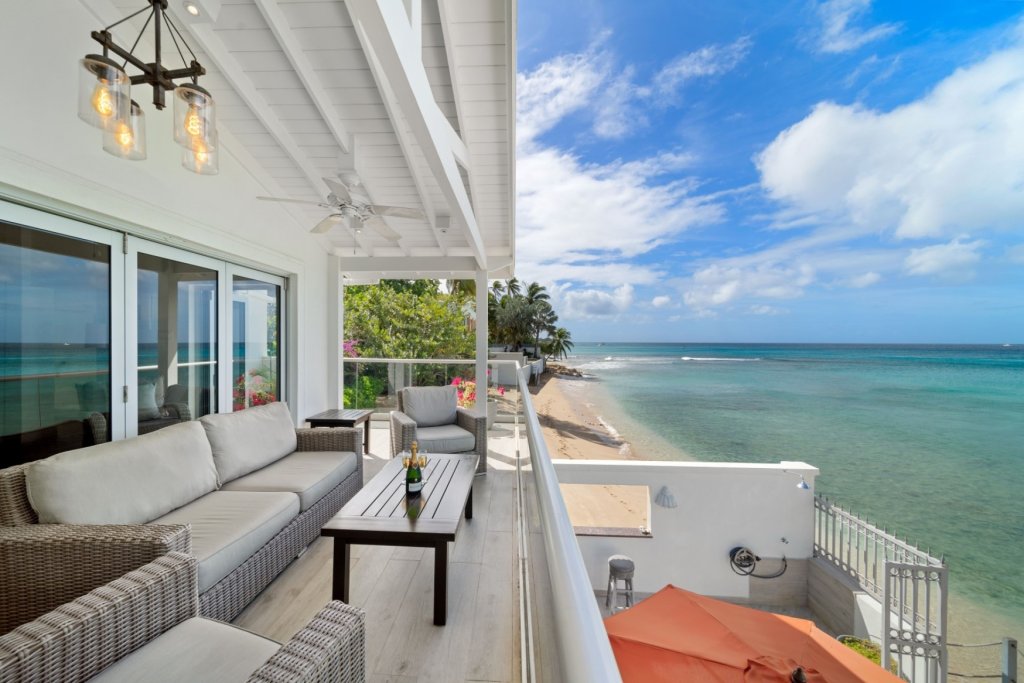 Westshore Beach House shaded oceanfront terrace overlooking the Barbados coastline