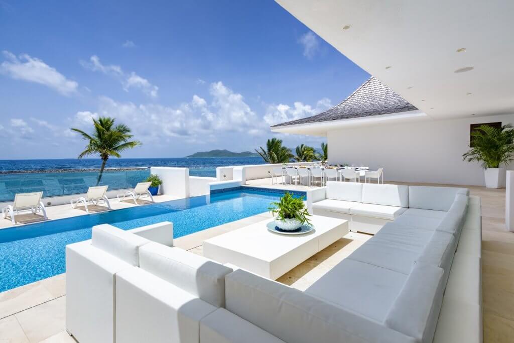Le Bleu’s pool, lounge and dining terrace overlook the sea for travelers choosing where to stay in Anguilla.