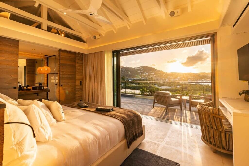 King suite with a private terrace and lagoon views at Tourmaline, a St Barts family villa.