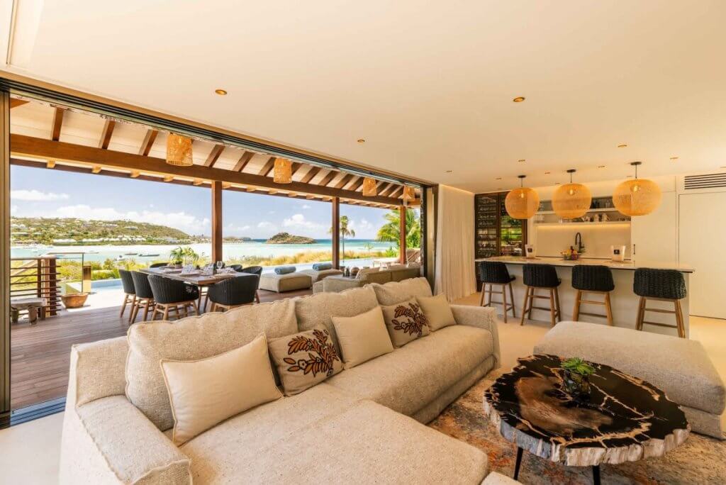 Open-plan living room and kitchen with lagoon views at Tourmaline, a St Barts family villa.