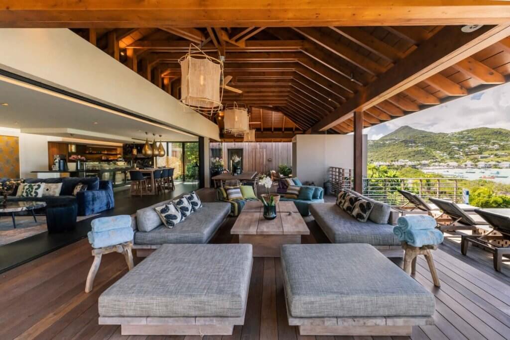 Larimar, St Barts, for special occasion travel: covered terrace with cushioned sofas, dining space and lagoon views.